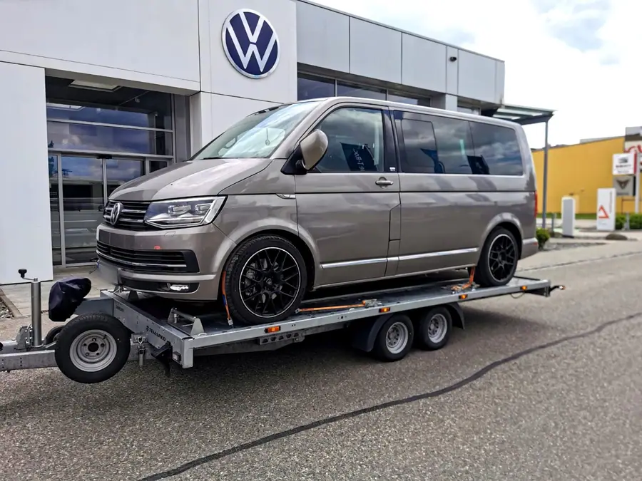 Champagnerfarbener VW T6 Multivan verladen vor einem Autohaus
