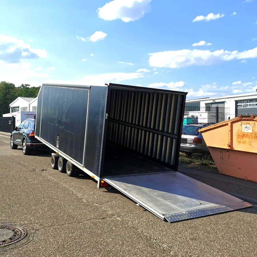 Geschlossener Autotransportanhänger mit heruntergelassener Laderampe